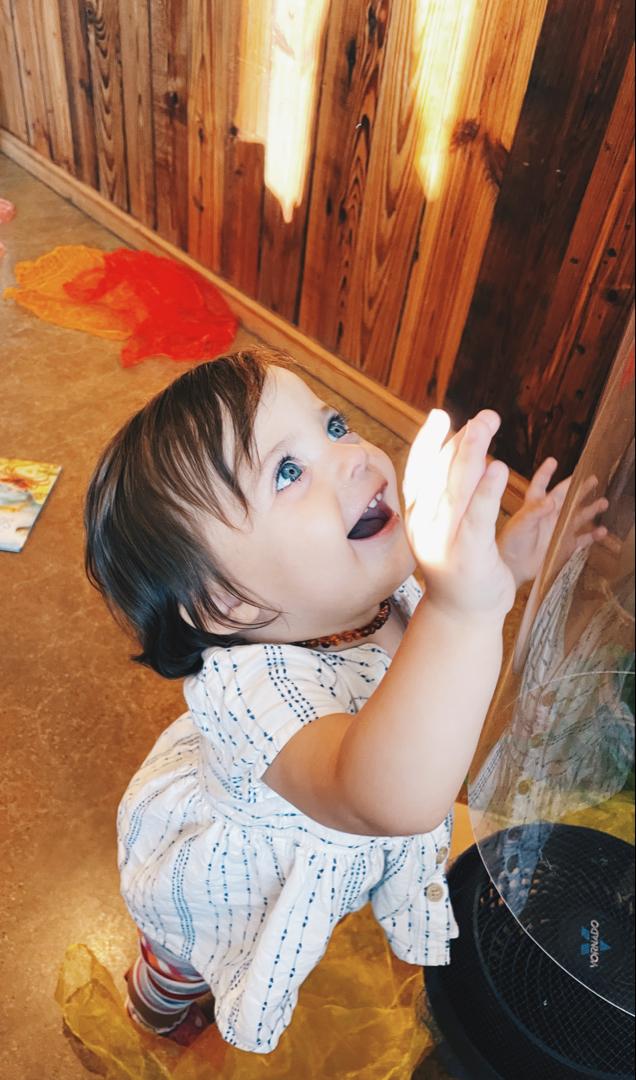 Emerging toddler smiling during activity